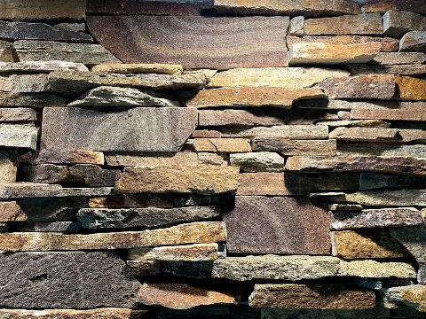 Layered stone wall featuring earthy tones and textures