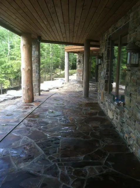 Flagstone patio with wooden beams and natural surroundings